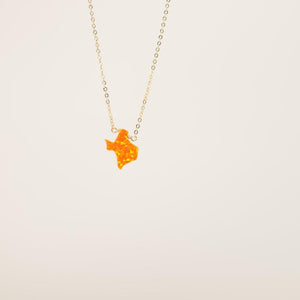 Orange Texas charm on gold necklace