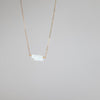 Small Nebraska state pendant in white opal on gold necklace chain