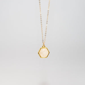 Small hexagon rose quartz charm in gold