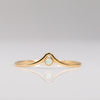 Delicate gold ring with chevron arch and small round opal stone