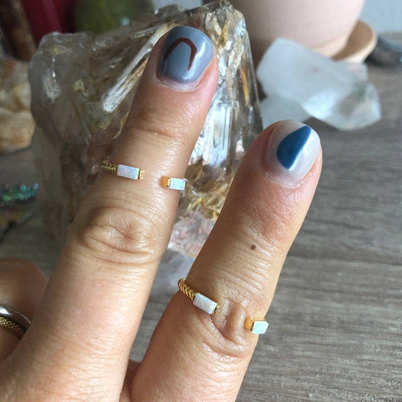 Small open gold twist ring with mini opal bar stones