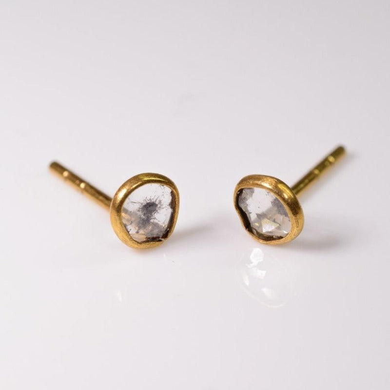 Beautiful mirror-like round diamond studs set flush in gold