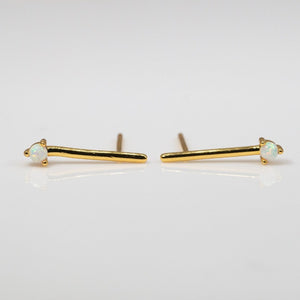 Small opal stones set on a simple gold bar stud earrings