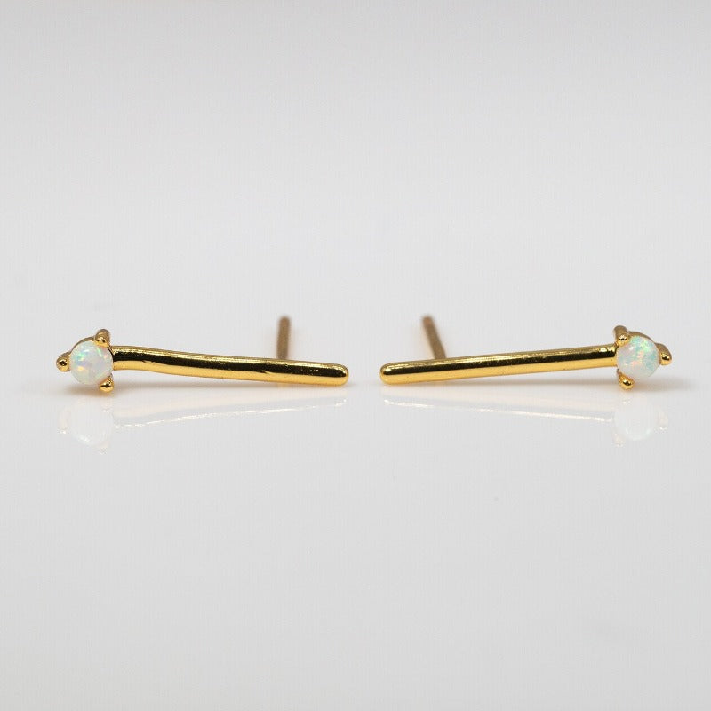 Small opal stones set on a simple gold bar stud earrings