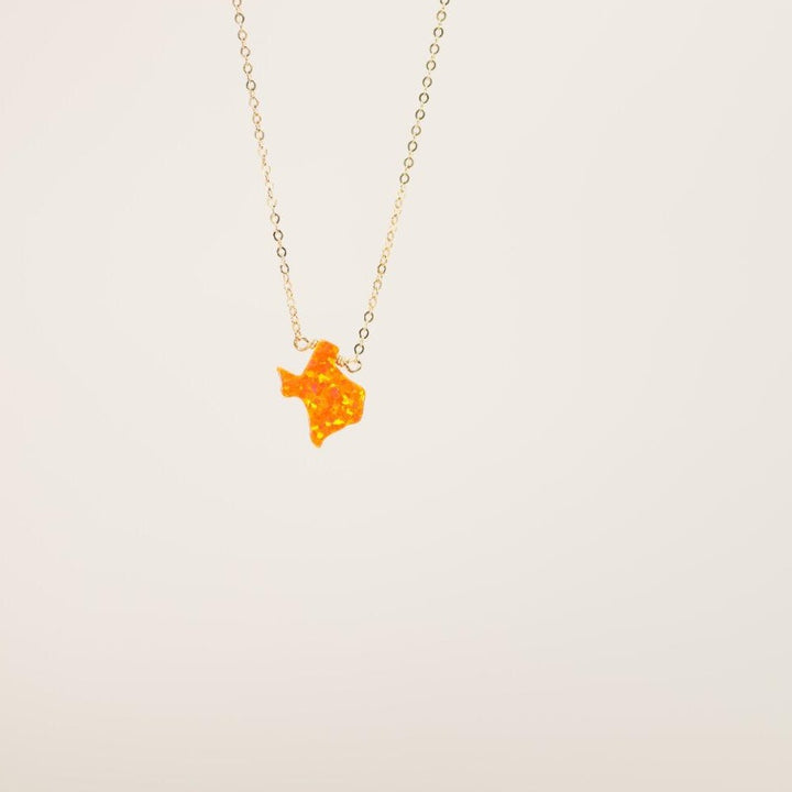 Orange Texas charm on gold necklace