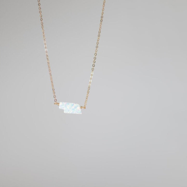 Small Nebraska state pendant in white opal on gold necklace chain