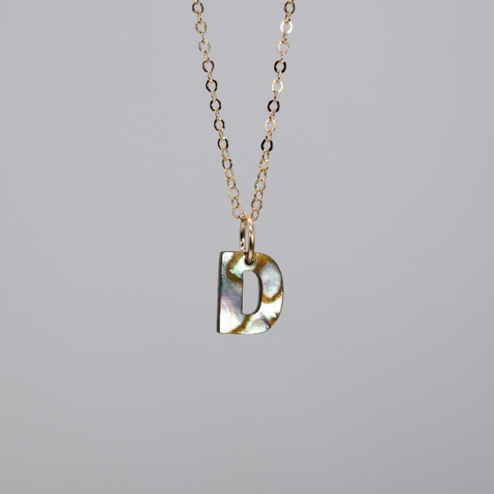 Delicate iridescent abalone "D" pendant 