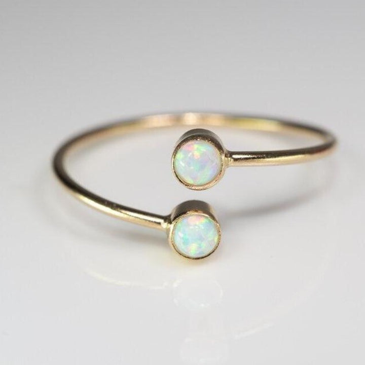 Double set opal ellipsis ring in gold