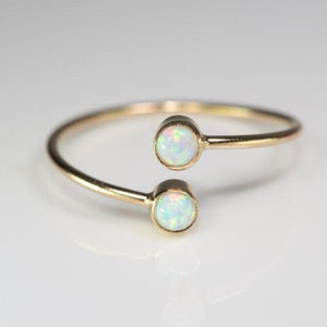 Double set opal ellipsis ring in gold