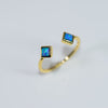 Blue opal square cut stones with a gold cuff band ring