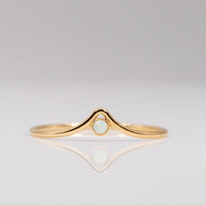 Delicate gold ring with chevron arch and small round opal stone